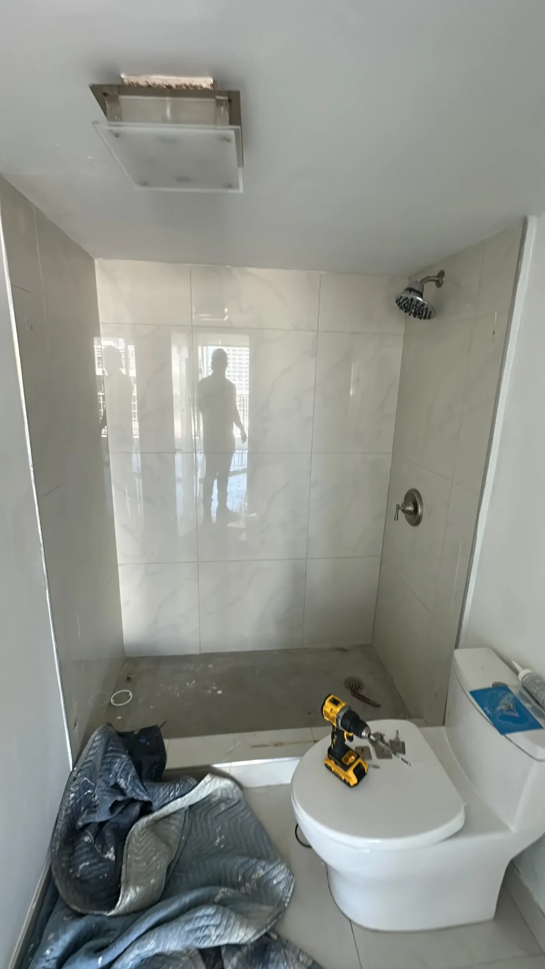 Bathroom remodel in progress with new tile and fixtures installed