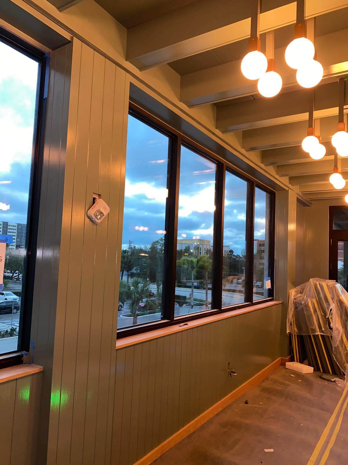 Restaurant window wall with millwork and pendant lights