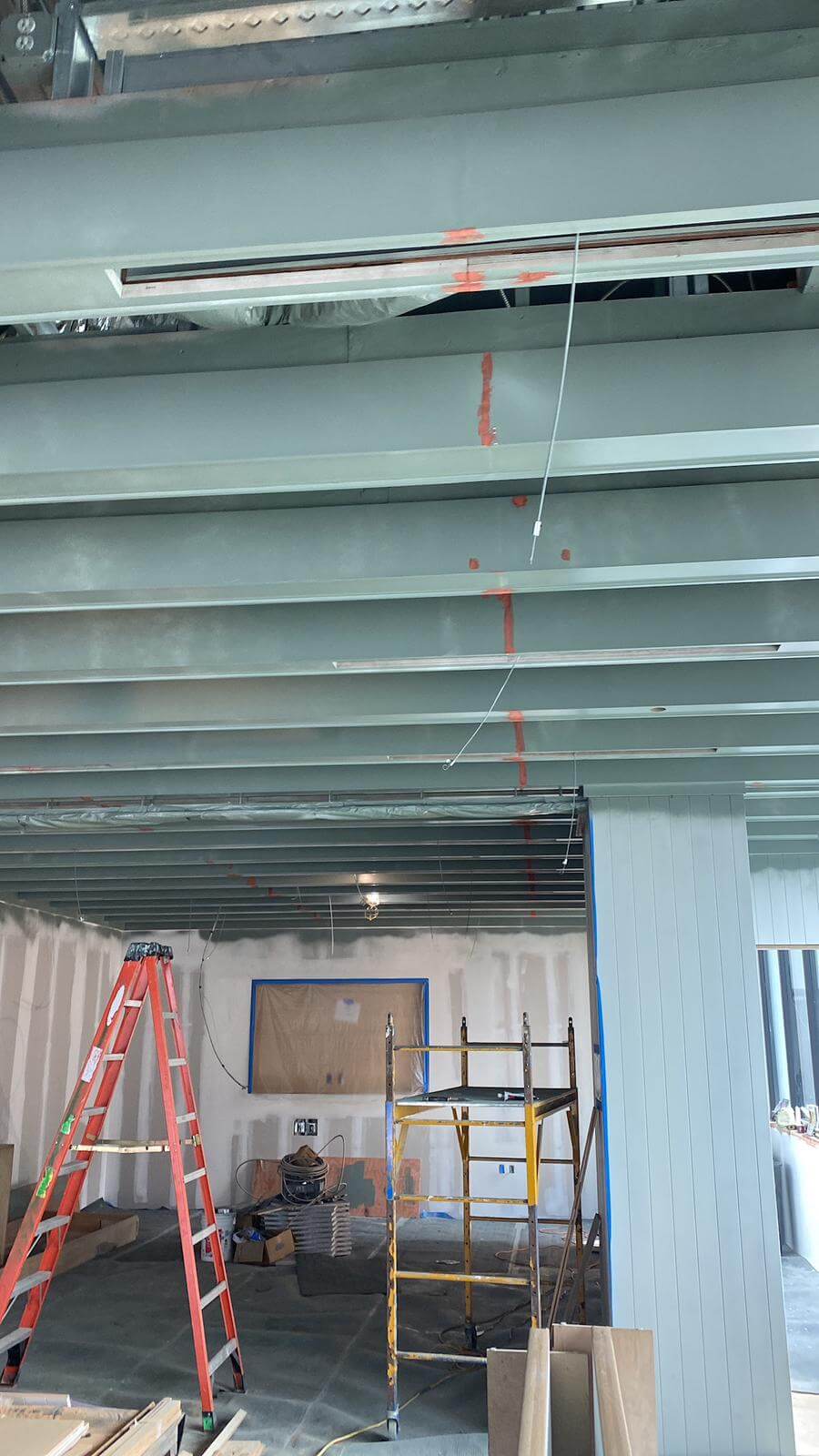 Framed ceiling and shiplap column detail in a commercial space