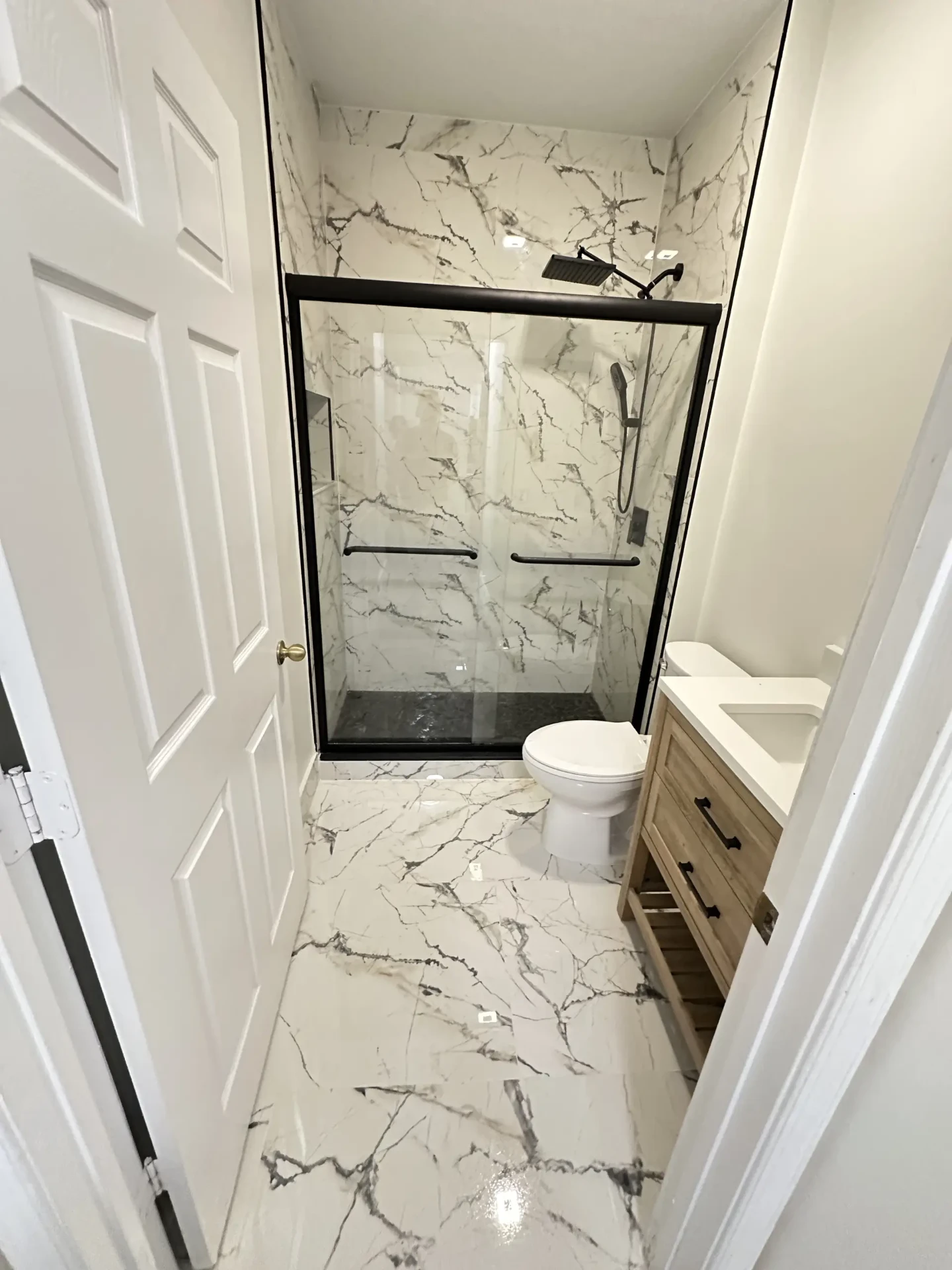 Completed walk-in shower with black frame glass door