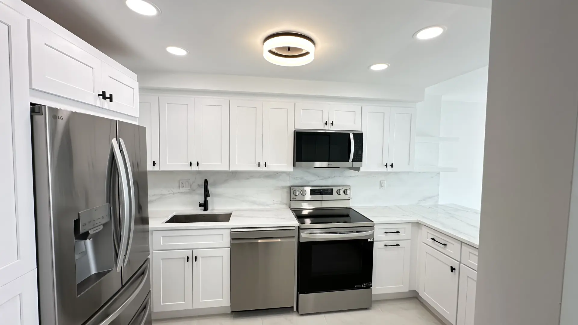 Completed white shaker kitchen with stainless appliances