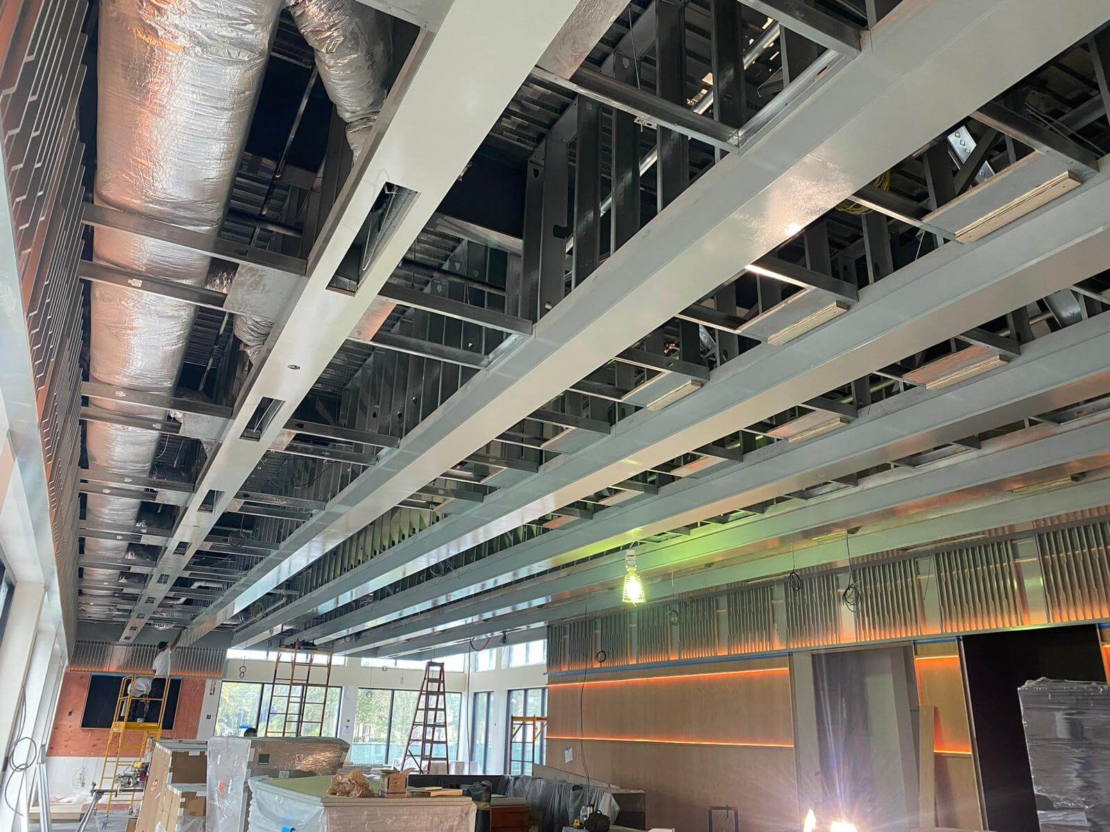 Exposed steel beams and slatted wood ceiling detail