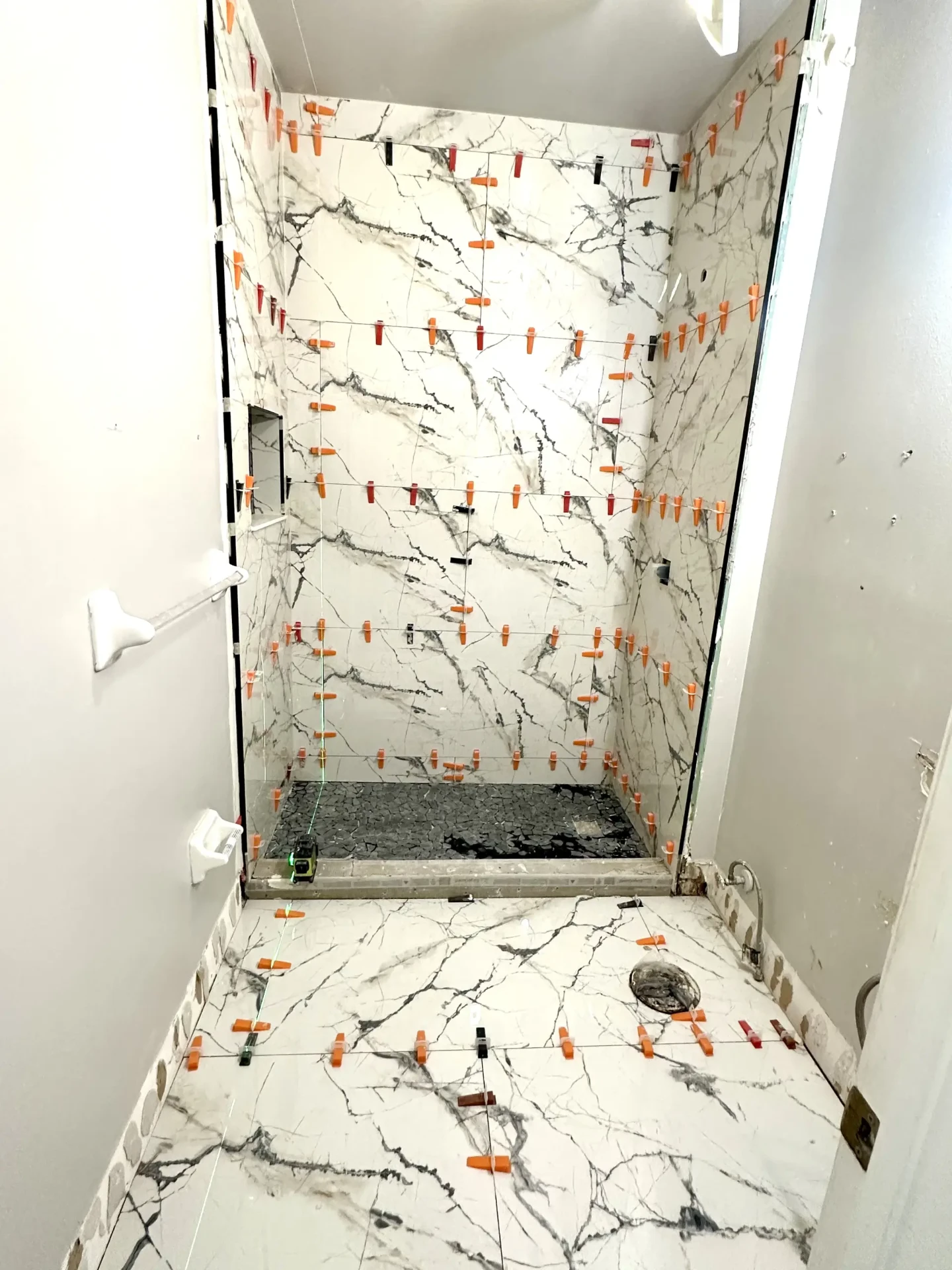 Shower fully tiled with pebble floor before grouting