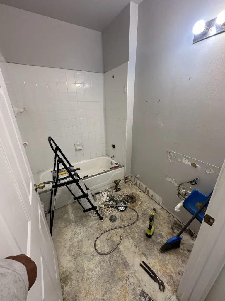 Original bathroom before demolition with old tub and dated tile