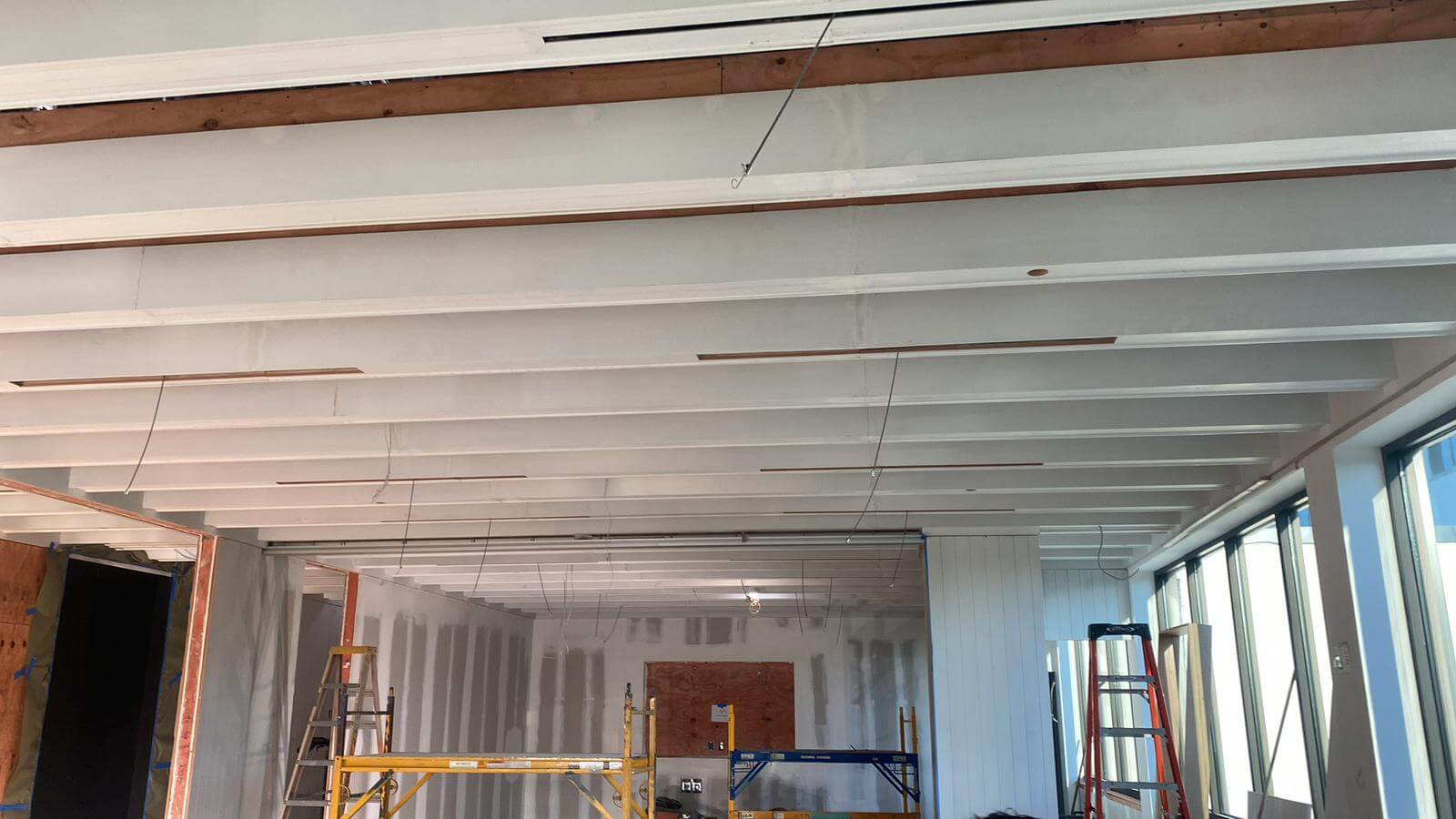 Painted beam ceiling in a commercial restaurant interior