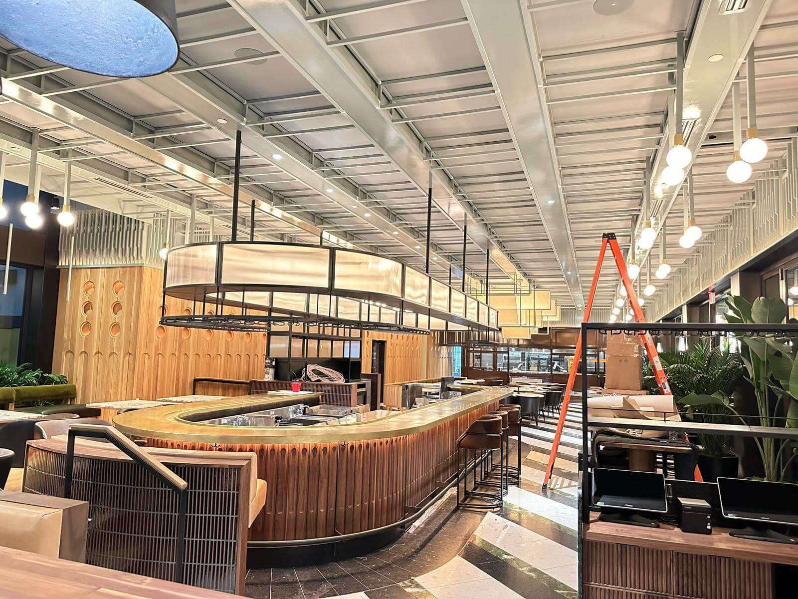 Finished restaurant interior with wood paneling and curved bar