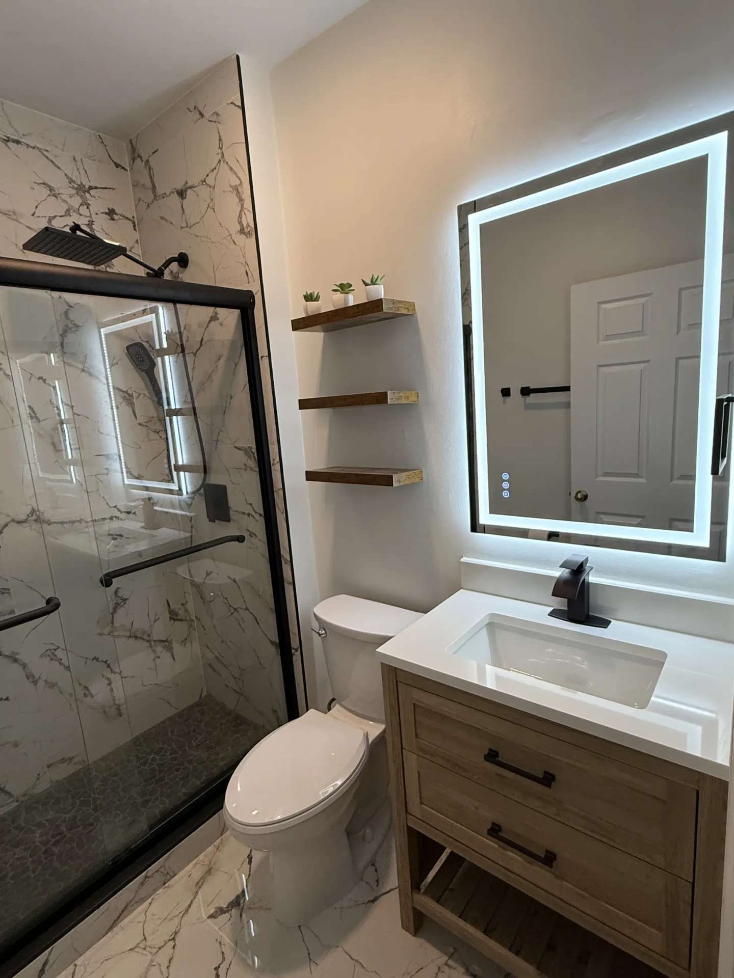 Finished bathroom with LED mirror and oak vanity